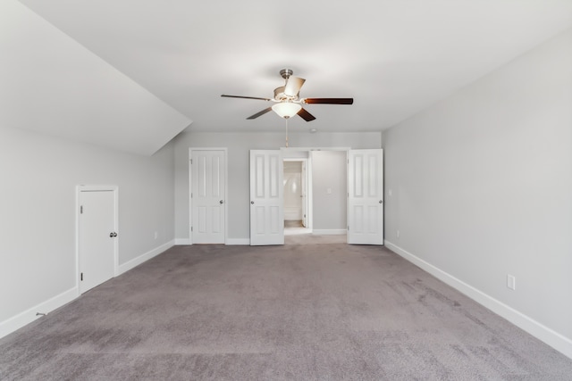 additional living space with light carpet, vaulted ceiling, and ceiling fan