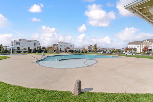 view of swimming pool with a patio area