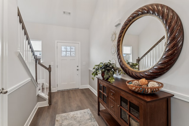 foyer featuring vaulted ceiling and dark hardwood / wood-style floors