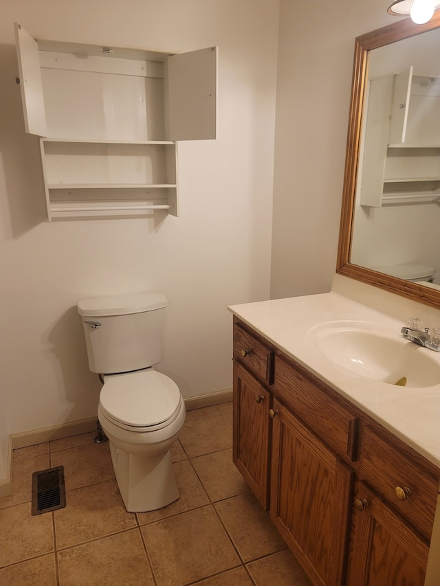 bathroom featuring tile patterned flooring, vanity, and toilet