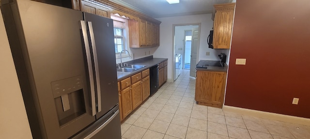 kitchen with light tile patterned floors, sink, and black appliances