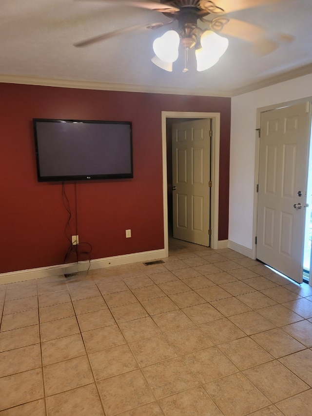 unfurnished living room featuring ceiling fan, light tile patterned flooring, baseboards, and ornamental molding