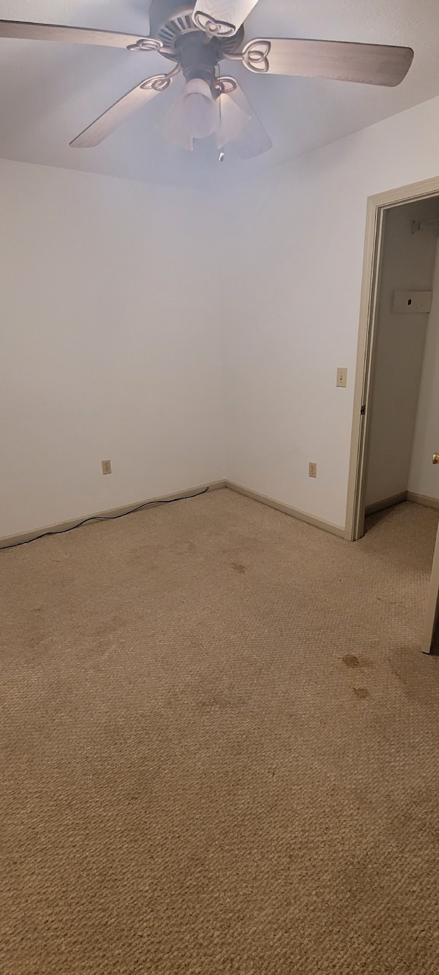 carpeted empty room with ceiling fan