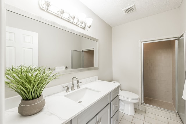 bathroom featuring vanity, an enclosed shower, toilet, tile patterned floors, and a textured ceiling