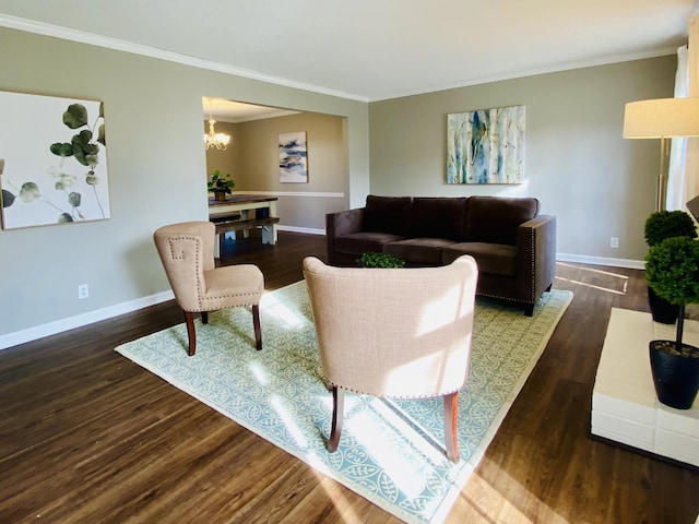 living room with crown molding, dark hardwood / wood-style flooring, and a chandelier