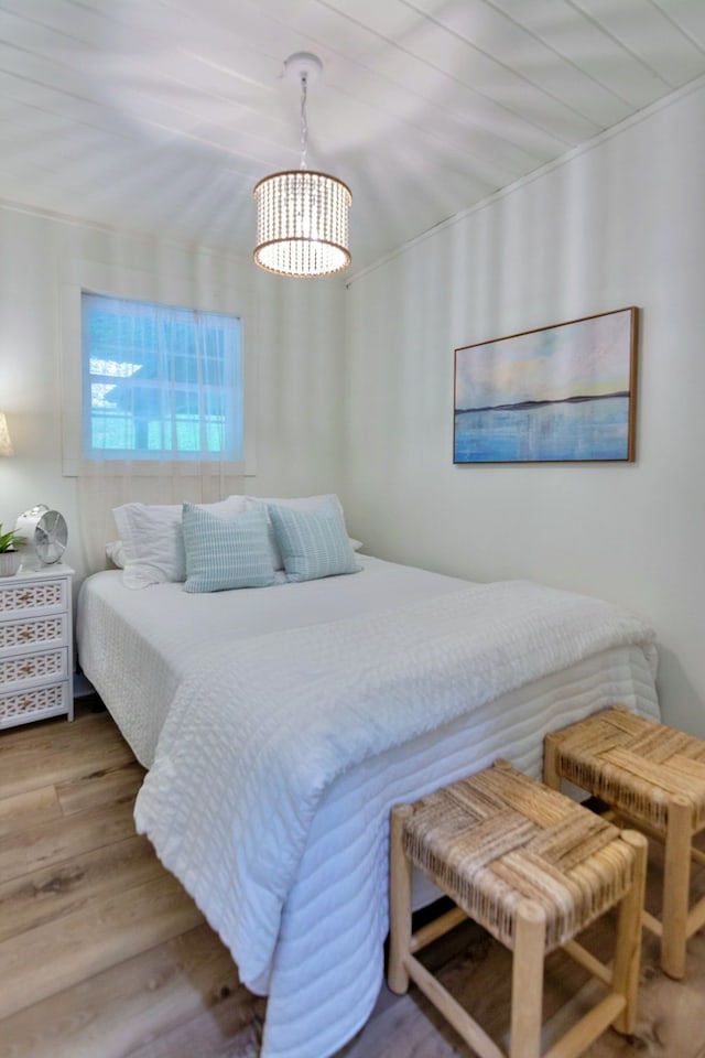 bedroom featuring hardwood / wood-style floors and wooden ceiling