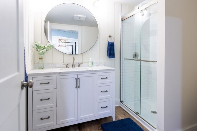 bathroom with vanity, hardwood / wood-style flooring, and an enclosed shower