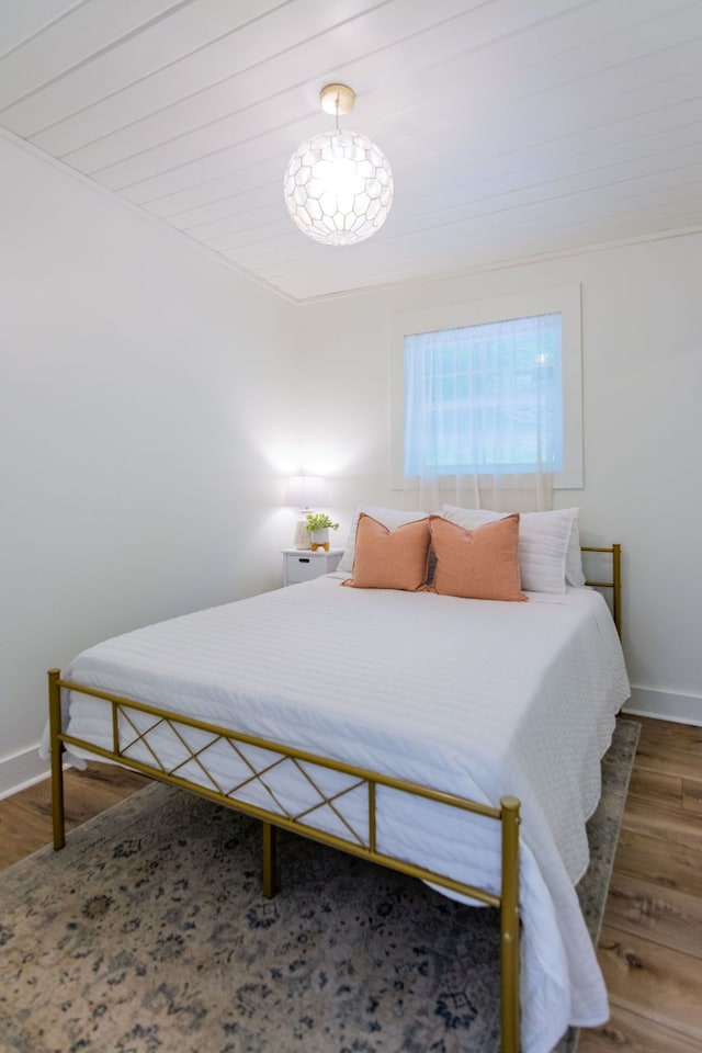 bedroom with dark hardwood / wood-style flooring