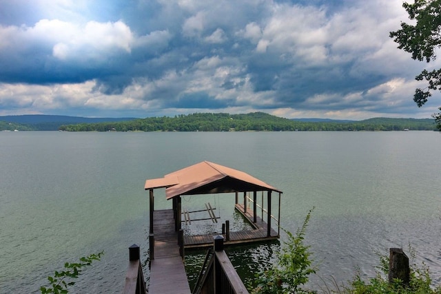 view of dock featuring a water and mountain view