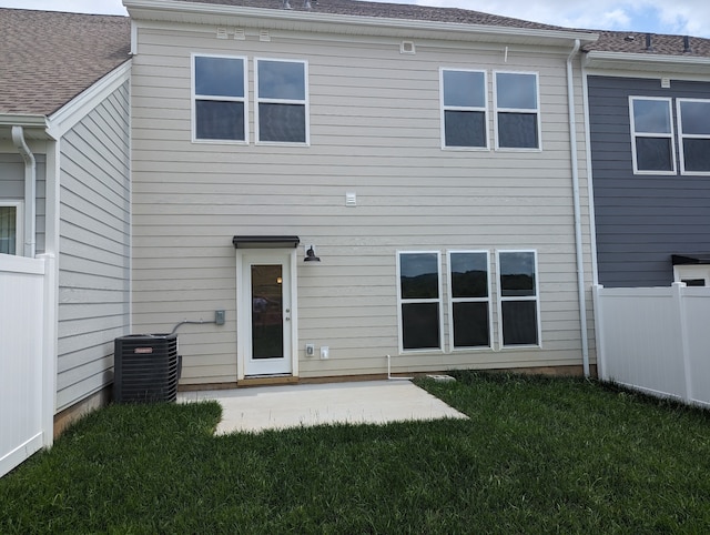 back of house with a lawn, central AC, and a patio area