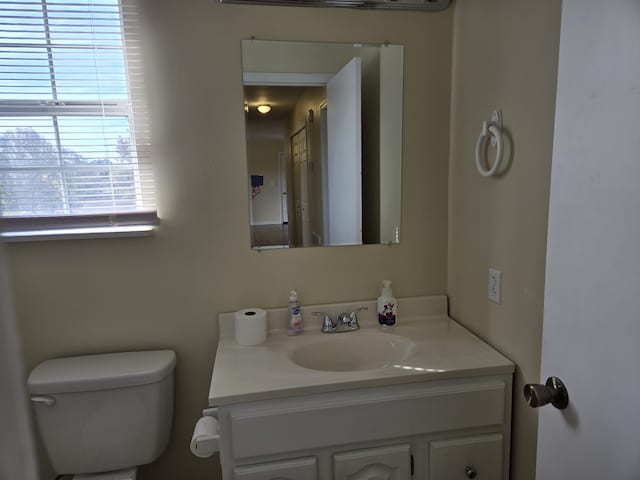 bathroom featuring vanity and toilet