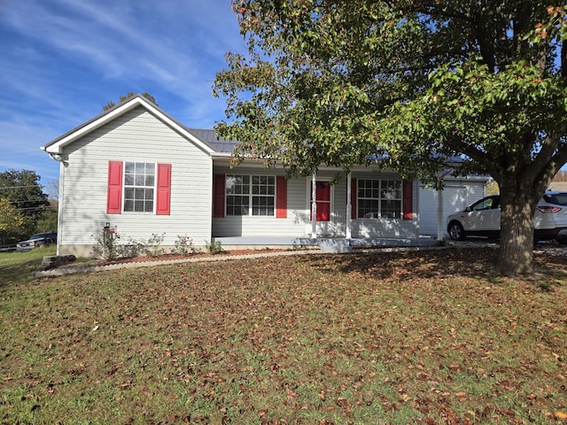 single story home featuring covered porch and a front yard