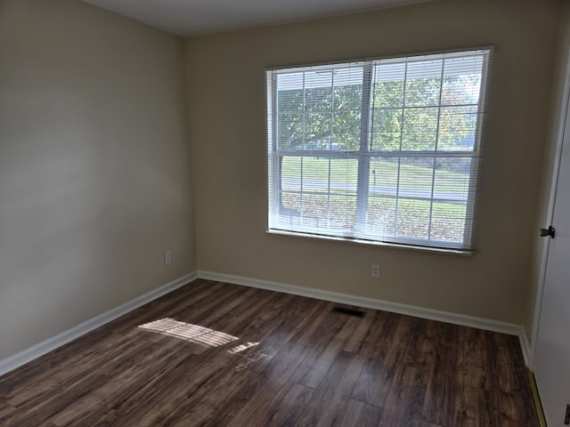 empty room with dark wood-type flooring