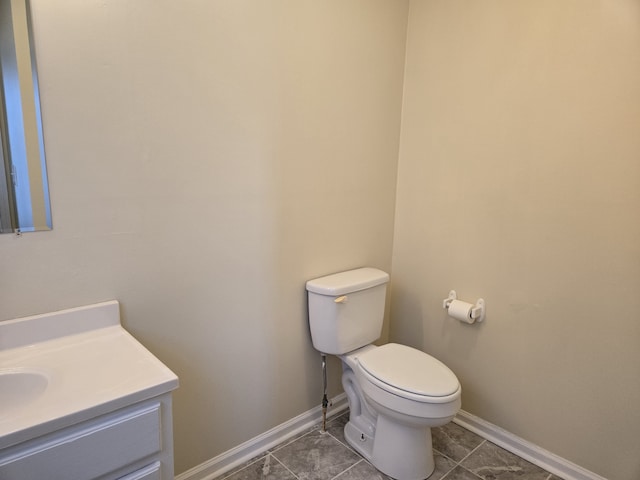 bathroom with vanity, toilet, and tile patterned flooring