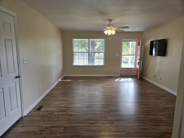 unfurnished living room with dark hardwood / wood-style floors and ceiling fan