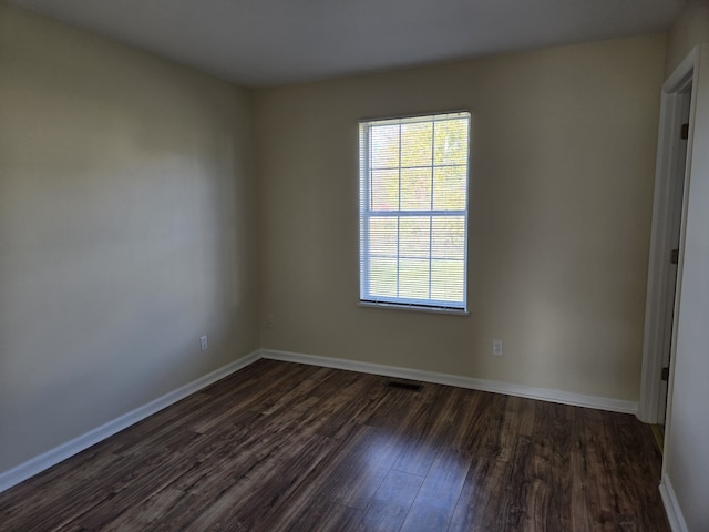 empty room with dark wood-type flooring