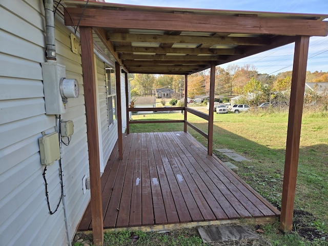 wooden deck featuring a lawn