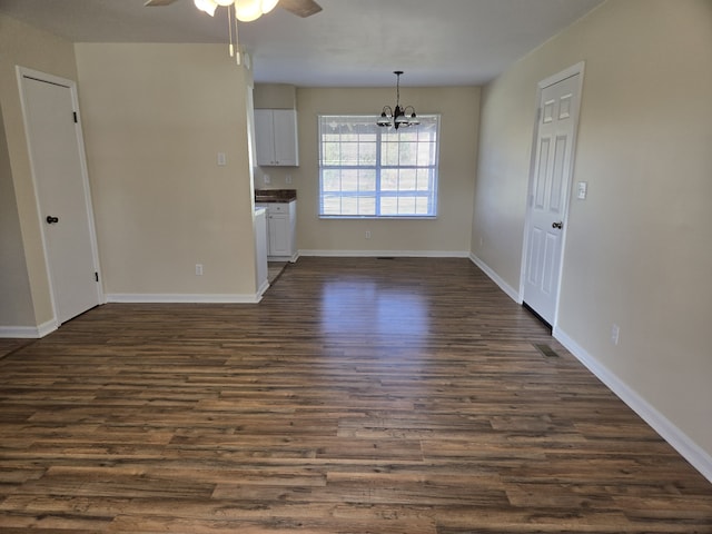 interior space with dark hardwood / wood-style floors and ceiling fan with notable chandelier