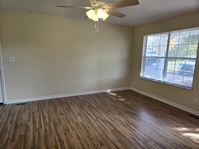 spare room featuring ceiling fan and dark hardwood / wood-style floors