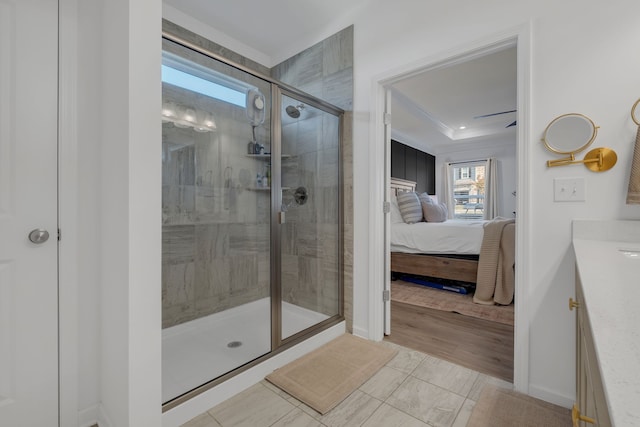 bathroom with a shower with door, hardwood / wood-style floors, vanity, and ornamental molding