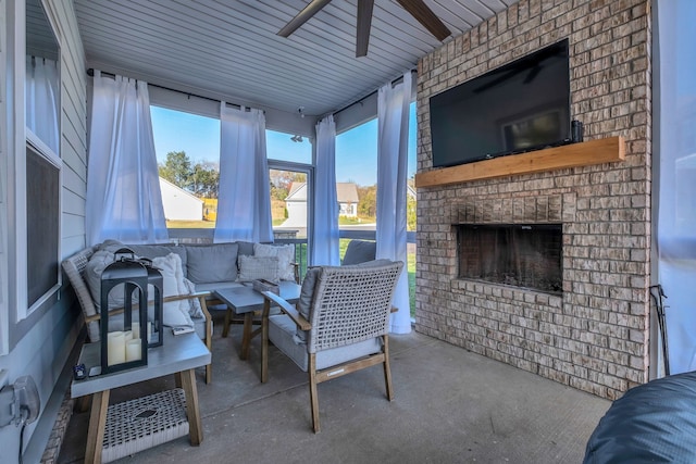 interior space featuring an outdoor living space with a fireplace and ceiling fan