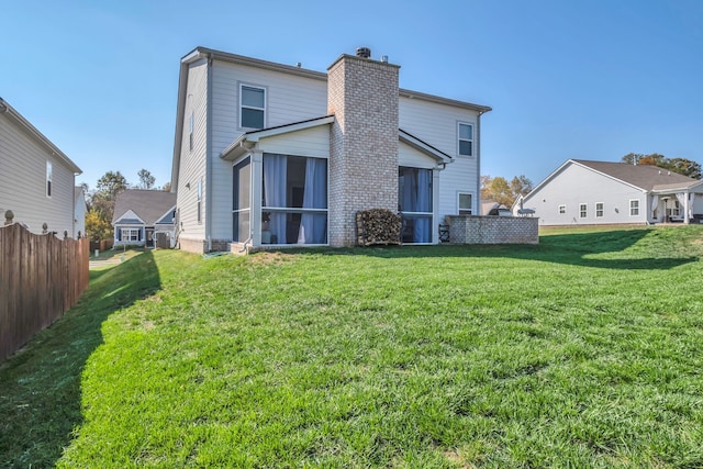 back of house with a lawn