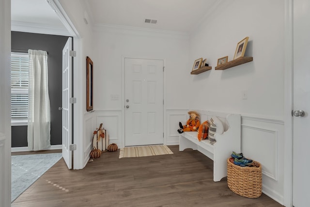 interior space featuring dark wood-type flooring and crown molding