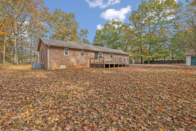 rear view of house with central air condition unit and a wooden deck