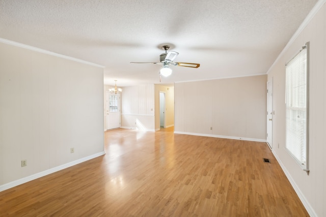 spare room with light hardwood / wood-style floors, crown molding, and a wealth of natural light