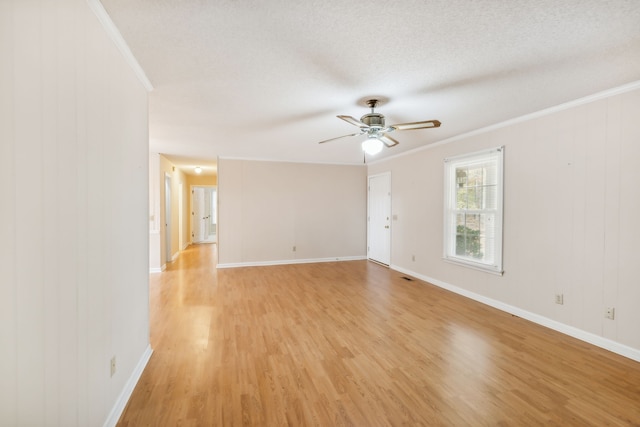 unfurnished room featuring ceiling fan, a textured ceiling, light wood-type flooring, and ornamental molding