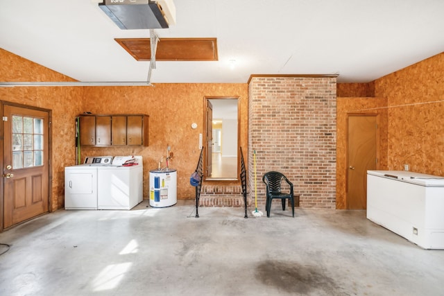 garage featuring electric water heater, washing machine and dryer, a garage door opener, and refrigerator