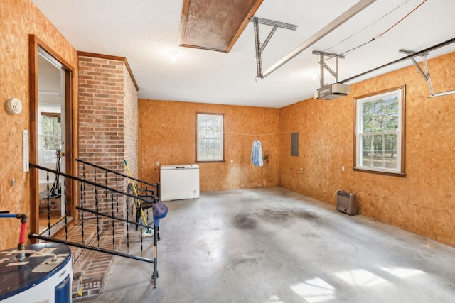 garage with a garage door opener, water heater, and white refrigerator