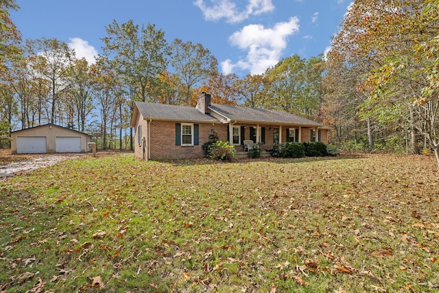 ranch-style home featuring an outbuilding, a garage, and a front yard