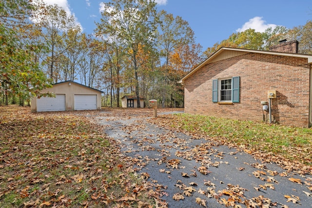 view of side of property featuring an outbuilding and a garage