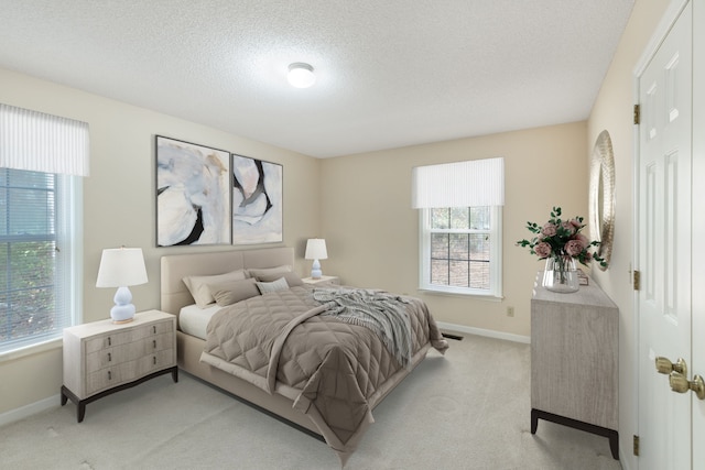 carpeted bedroom featuring a textured ceiling