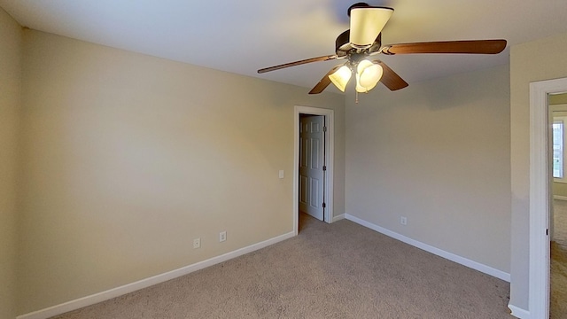 carpeted empty room with ceiling fan