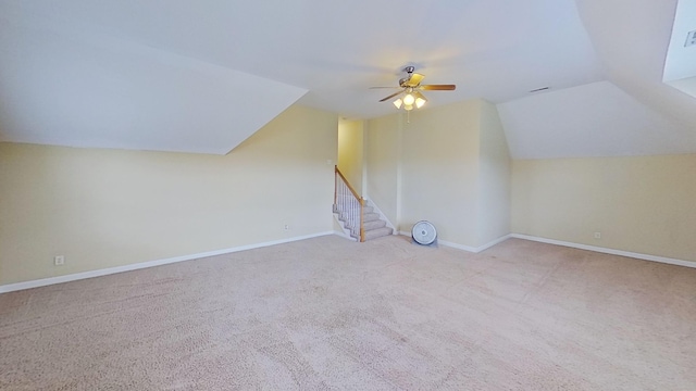 additional living space with light colored carpet, vaulted ceiling, and ceiling fan