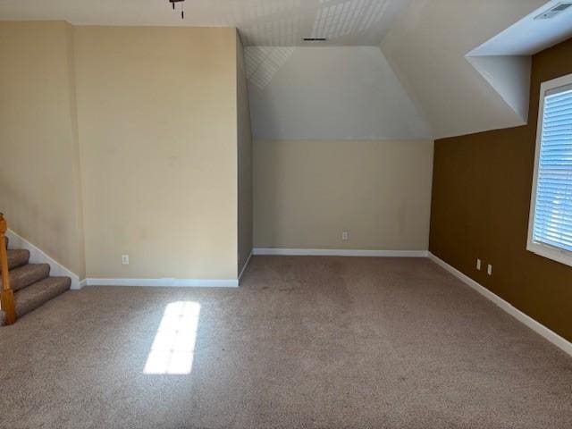 bonus room featuring light colored carpet and vaulted ceiling