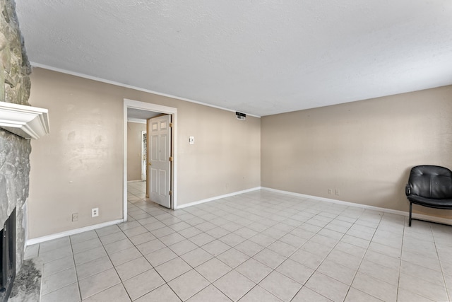 unfurnished living room with a textured ceiling, light tile patterned floors, and a fireplace