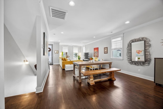 dining space with crown molding, plenty of natural light, and dark hardwood / wood-style floors