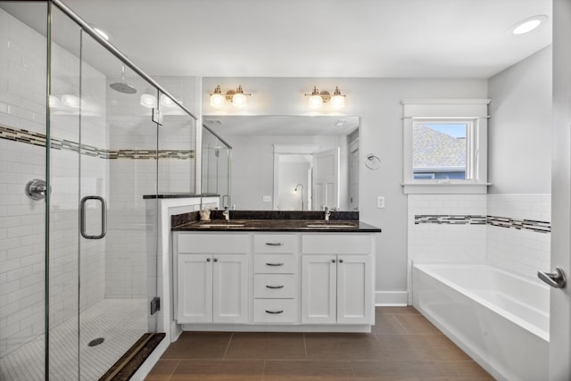 bathroom featuring vanity and plus walk in shower