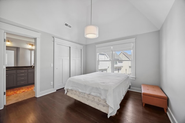 bedroom with lofted ceiling and dark hardwood / wood-style flooring