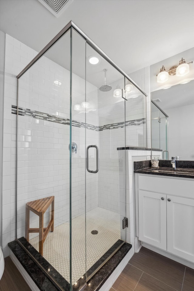 bathroom featuring vanity and an enclosed shower