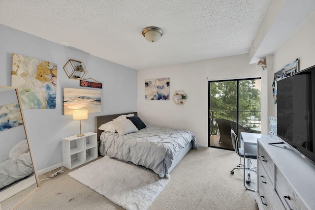 bedroom featuring light carpet, a desk, access to outside, a textured ceiling, and baseboards