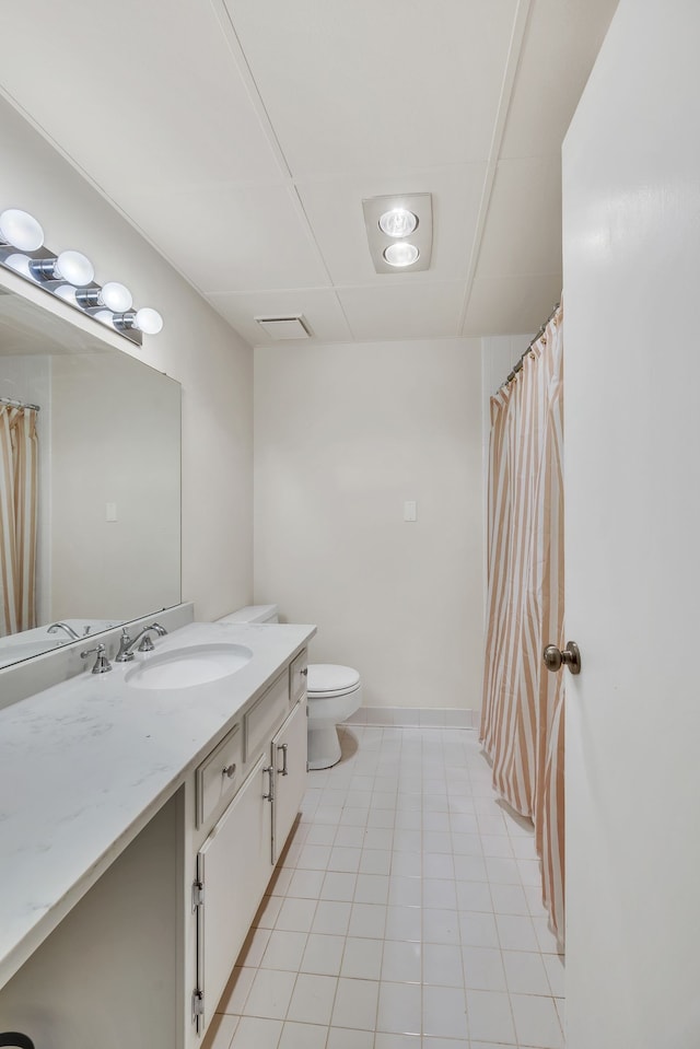 bathroom with vanity, toilet, and tile patterned flooring