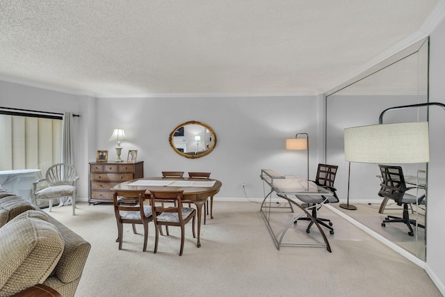 carpeted dining room with ornamental molding, baseboards, and a textured ceiling
