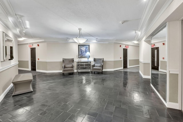 building lobby with ornamental molding and a textured ceiling