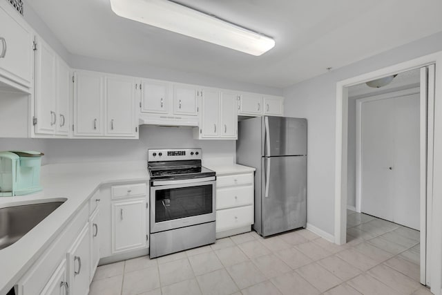 kitchen with stainless steel appliances, under cabinet range hood, white cabinetry, and light countertops