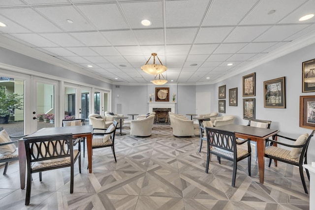 dining area with a fireplace, recessed lighting, french doors, and crown molding