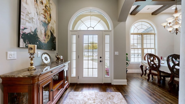 entryway featuring dark wood-type flooring, coffered ceiling, beamed ceiling, and a chandelier